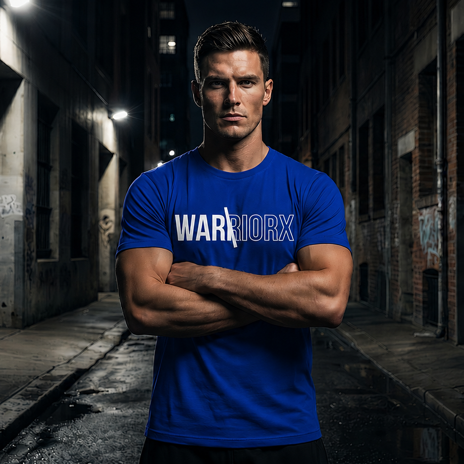 Man wearing a blue 'Warrior' t-shirt standing in a dark alleyway.